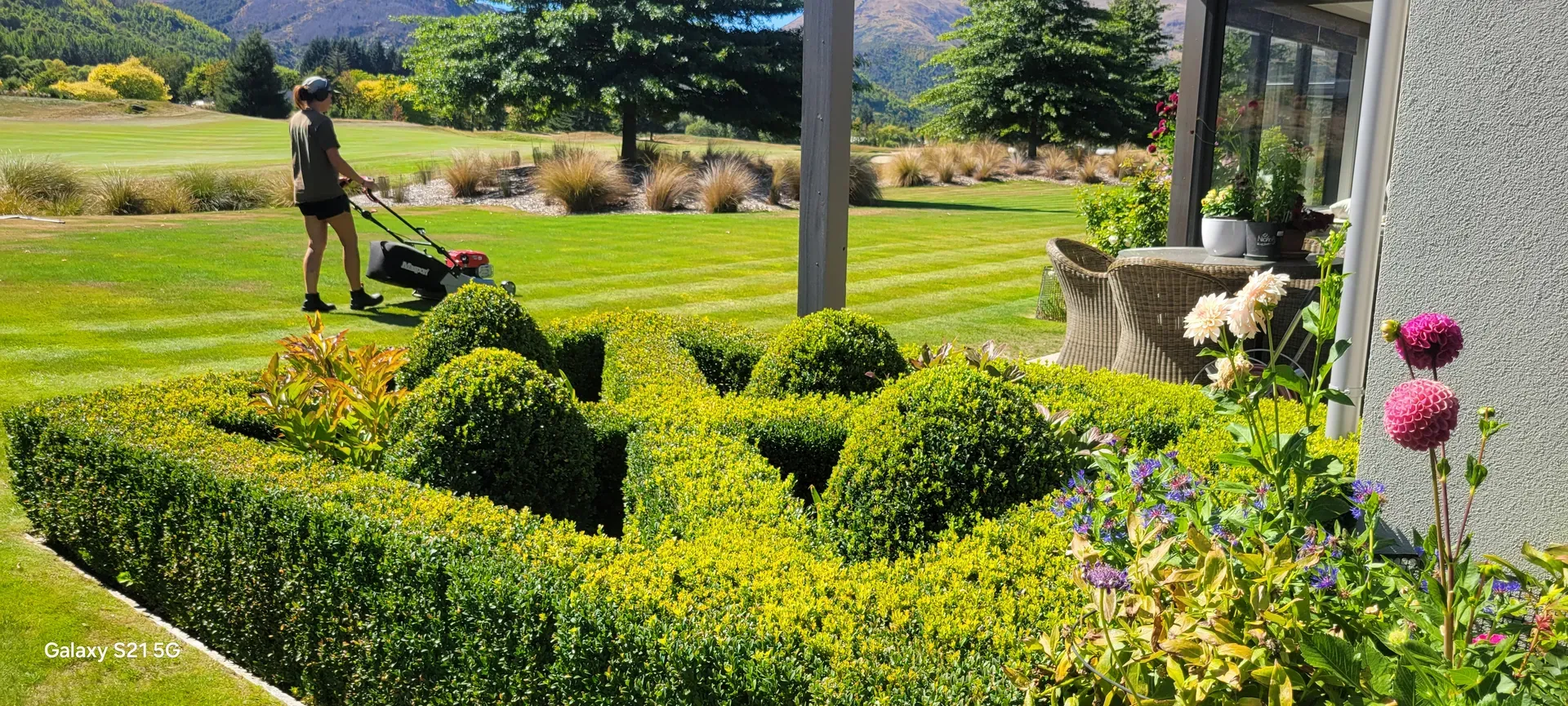 Professional landscape mowing under clear Central Otago skies